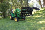 Open John Deere Green Tractor with black Stinger claw Attachment