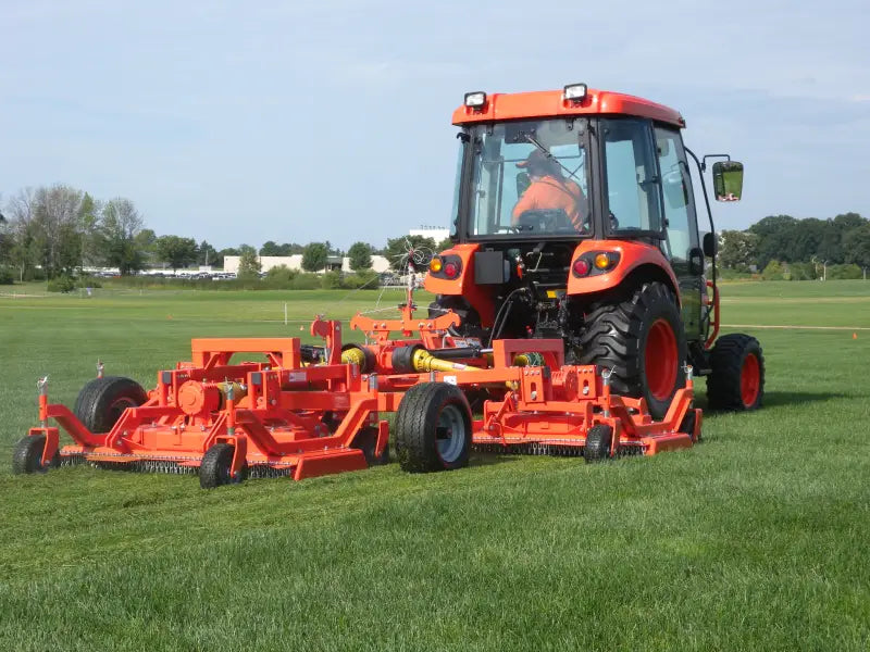 Tractor with BEFCO CYCLONE FLEX gang mower, mowing a large grassy field, highlighting its wide-area coverage.