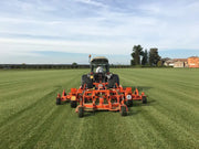 BEFCO CYCLONE SUPER-FLEX mower attached to a tractor, demonstrating its wide-area cutting capability on a field.