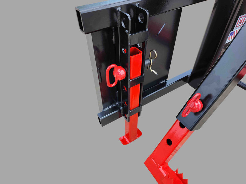 Detail of the skid steer tire grabber's mounting bracket, highlighting the robust steel construction and red accents.