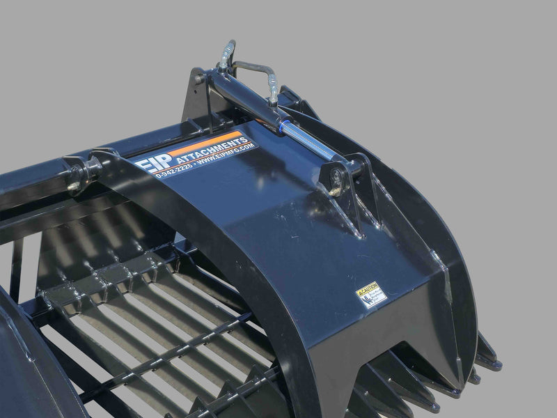 Close-up of EIP grapple bucket's hydraulic cylinder and steel tines, showcasing robust construction and design.