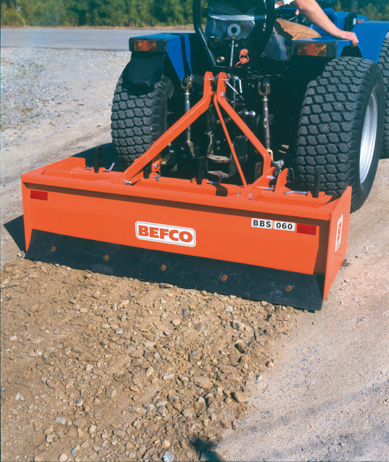 BEFCO BBS box blade mounted on a tractor, illustrating its use in soil grading and leveling.