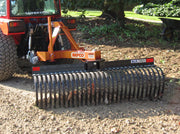 BEFCO Landscape Rake attached to a tractor, demonstrating grading on a dirt surface with precision.
