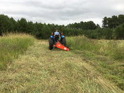 Tractor with BEFCO Sickle Bar Mower in field, highlighting efficient mowing of tall grass and weeds.