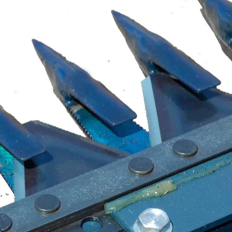 Detail of BEFCO Sickle Bar Mower's spring-loaded upper blade guides, enhancing blade stability and cooling.