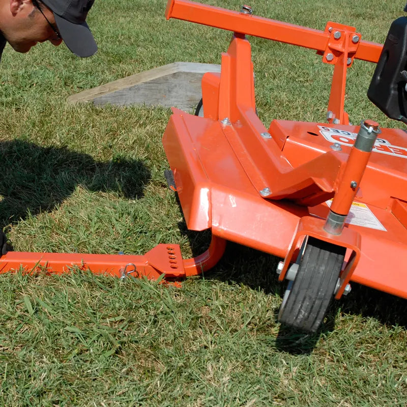 Close-up of BEFCO mower's wheel and hitch, showing the sturdy construction and adjustable swivel locks.