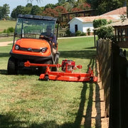 BEFCO mower in action, trimming grass along a fence line with an ATV, illustrating its precise cutting ability.