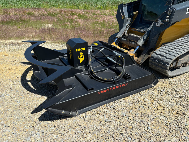 Brush cutter attached to a skid steer