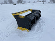 Angled view of SPX8 snow pusher in snowy landscape, showcasing its durable steel and design.
