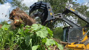 Close up of CG-XD Clam Grapple from Stinger Attachments operating in a forested area