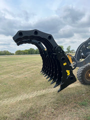 Side angle of black Stinger Attachment clam grapple attached to tractor