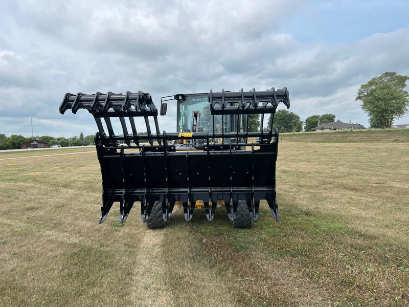 Open black Stinger Attachment claw attached to John Deere Tractor and operator