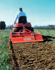 BEFCO TILL-RITE T30 rotary tiller in action, tilling a field, attached to a compact tractor.