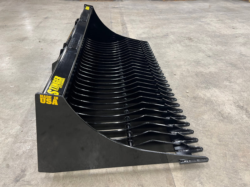 Side angle of black tractor rock bucket RK-82 Stinger Attachment detached from tractor