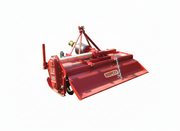 Red BEFCO rotary tiller with side-shift feature, suitable for compact tractors, showcasing robust build.